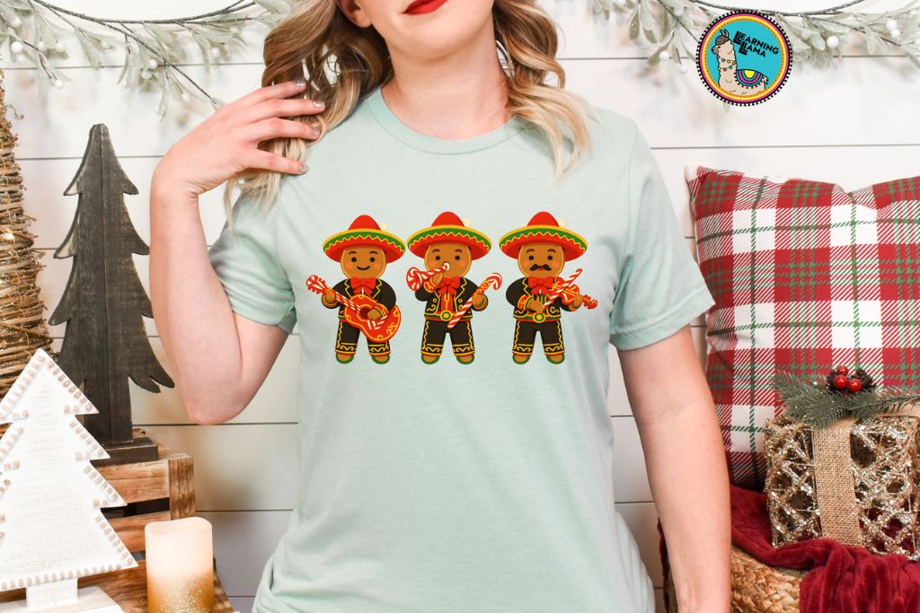 gingerbread shirt with three gingerbread men cookies dressed like mariachi band playing peppermint candy cane instruments for navidad or christmas